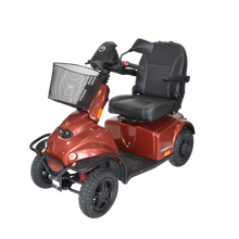 Afbeelding in Gallery-weergave laden, Het zijaanzicht van de Minicrosser scootmobiel in een oranje uitvoering
